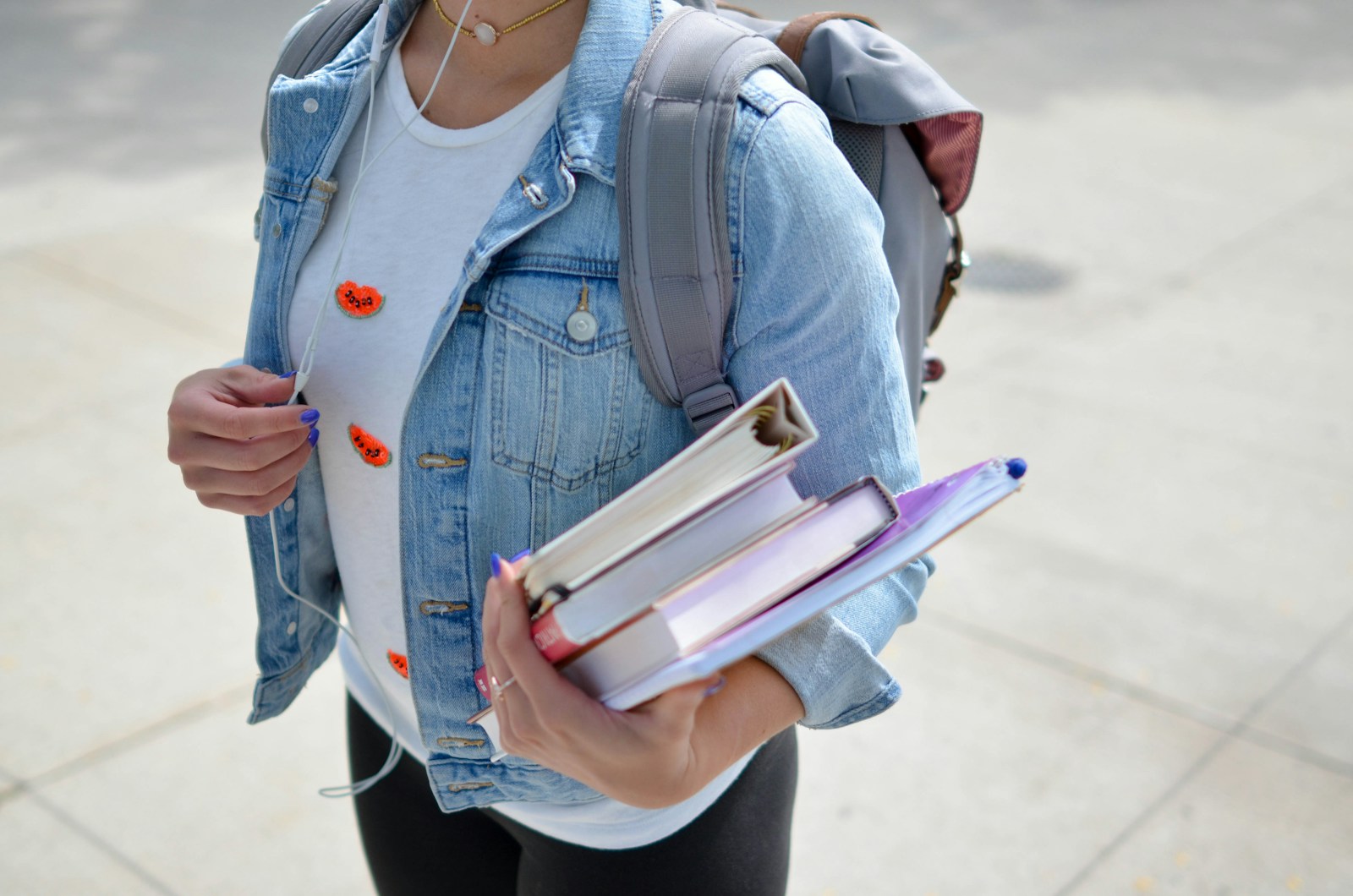 Photo by Element5 Digital woman wearing blue denim jacket holding book